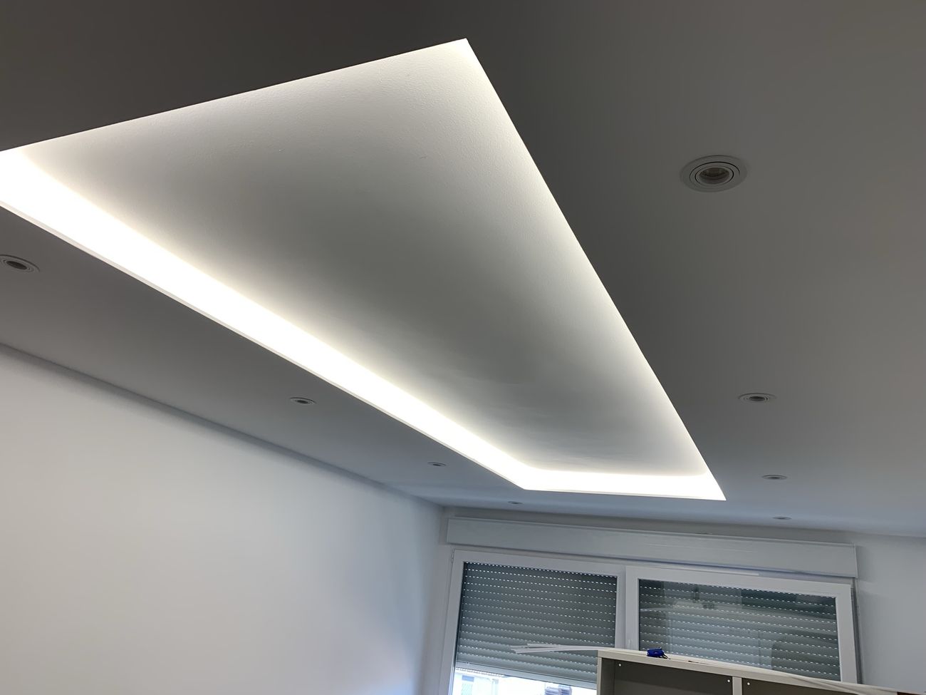 Drywall tray ceiling with hidden LED cove lighting and recessed spotlights