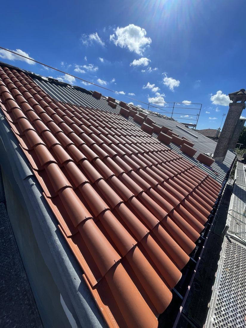 New clay tile roof installed over corrugated underlayment sheets