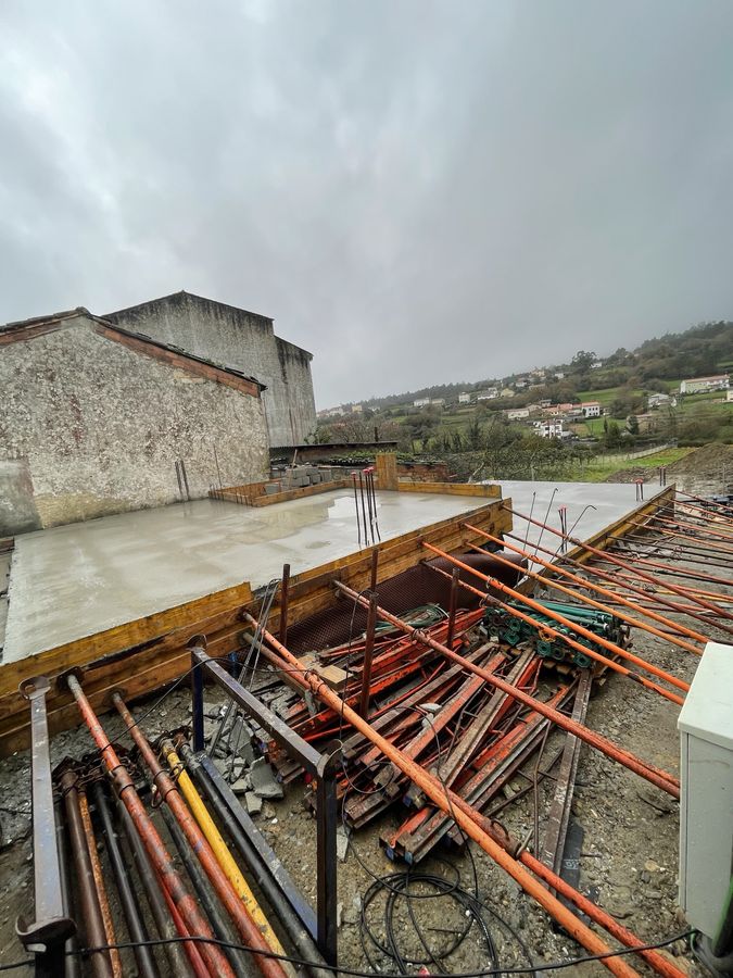 Freshly poured concrete slab with formwork and props on a new build